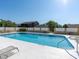 Community pool is surrounded by lounge chairs at 533 E Curlew Pl # 533, Tarpon Springs, FL 34689