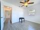 Bedroom featuring tile floors, ceiling fan and window with view of exterior at 5806 Liverpool Dr, Tampa, FL 33615