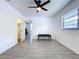 Bright bedroom featuring tile floors, a ceiling fan, and closet with a window that provides natural light at 5806 Liverpool Dr, Tampa, FL 33615