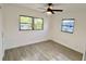 This bedroom has tile floors, ceiling fan and two windows to let in natural light at 5806 Liverpool Dr, Tampa, FL 33615