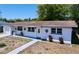 Well maintained exterior featuring white brick, updated windows, landscaping and a neatly kept front yard at 5806 Liverpool Dr, Tampa, FL 33615