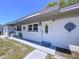 Charming home featuring a neatly landscaped yard, stylish entry door and crisp, freshly painted white exterior at 5806 Liverpool Dr, Tampa, FL 33615