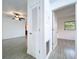 Hallway view with tile floors, with linen closet on the left, and bedroom at end of hall at 5806 Liverpool Dr, Tampa, FL 33615