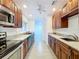 Updated kitchen features sleek appliances, ample counter space, wooden cabinets, and views into the living area at 5806 Liverpool Dr, Tampa, FL 33615