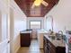 The laundry room features built in cabinets, granite counters, stainless sink, and white washer and dryer at 5806 Liverpool Dr, Tampa, FL 33615