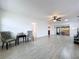 Bright living room with tile floors, ceiling fan, neutral walls and access to the screened-in patio at 5806 Liverpool Dr, Tampa, FL 33615