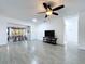 Living room with tile floors, a ceiling fan, and access to the sunroom at 5806 Liverpool Dr, Tampa, FL 33615