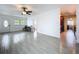 Open-concept living room features tile flooring, an inviting atmosphere, and views into the kitchen at 5806 Liverpool Dr, Tampa, FL 33615