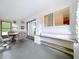 Enclosed sunroom features a glass table with seating, tile flooring, and natural lighting at 5806 Liverpool Dr, Tampa, FL 33615