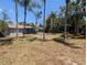 Backyard view of the charming home with a spacious yard, creating a peaceful outdoor oasis at 627 Riverside Dr, Tarpon Springs, FL 34689