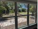 Bright, sunlit view of the backyard and patio from inside, showcasing the home's connection to nature at 627 Riverside Dr, Tarpon Springs, FL 34689