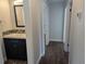 Bathroom with vanity, mosaic backsplash, updated fixtures, and hardwood floors at 627 Riverside Dr, Tarpon Springs, FL 34689