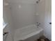 Bathroom features a white tiled shower and tub combo, and ceramic tile flooring at 627 Riverside Dr, Tarpon Springs, FL 34689