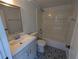 Bathroom features vanity, large mirror, and shower and tub combo with decorative tile floor at 627 Riverside Dr, Tarpon Springs, FL 34689
