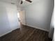 Bedroom with hardwood floors, light grey walls, and ceiling fan at 627 Riverside Dr, Tarpon Springs, FL 34689