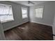 Bedroom features include hardwood floors, neutral paint, and natural lighting through three windows at 627 Riverside Dr, Tarpon Springs, FL 34689