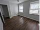 Bedroom features hardwood floors, neutral paint, and natural lighting through two windows at 627 Riverside Dr, Tarpon Springs, FL 34689
