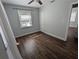 Bedroom with hardwood floors, neutral walls, ceiling fan, and natural lighting from window at 627 Riverside Dr, Tarpon Springs, FL 34689