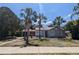 Charming single-story home with palm trees and landscaped front yard, perfect for Florida living at 627 Riverside Dr, Tarpon Springs, FL 34689