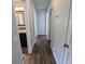 Hallway featuring wood floors, leading to the bedrooms and bathrooms at 627 Riverside Dr, Tarpon Springs, FL 34689