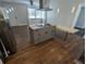 Modern kitchen island with granite countertop and built-in cooktop, perfect for entertaining at 627 Riverside Dr, Tarpon Springs, FL 34689
