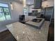 Granite countertops and modern appliances highlight the open and airy updated kitchen space at 627 Riverside Dr, Tarpon Springs, FL 34689