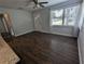 Bright living room with a large window and wood-look flooring, creating a welcoming atmosphere at 627 Riverside Dr, Tarpon Springs, FL 34689