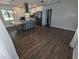 Open-concept living room with wood floors flows into a kitchen with a large island at 627 Riverside Dr, Tarpon Springs, FL 34689