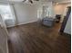 Spacious living area featuring laminate flooring, an island, and abundant natural light, creating a welcoming atmosphere at 627 Riverside Dr, Tarpon Springs, FL 34689