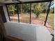 Cozy screened porch overlooking a well-maintained yard, ideal for enjoying the outdoors bug-free at 627 Riverside Dr, Tarpon Springs, FL 34689