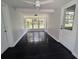 Bright sunroom with walls of windows and a ceiling fan providing a relaxing space at 627 Riverside Dr, Tarpon Springs, FL 34689