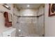 Bathroom with tiled shower, glass doors, and towel racks, offering a clean and modern design at 7867 Sailboat Key S Blvd # 101, South Pasadena, FL 33707