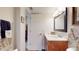 Bright bathroom with a wood vanity, a large mirror, and decorative towel arrangements at 7867 Sailboat Key S Blvd # 101, South Pasadena, FL 33707