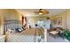 Spacious bedroom with a tropical ceiling fan, sliding doors to a balcony, and an adjoining bathroom at 7867 Sailboat Key S Blvd # 101, South Pasadena, FL 33707