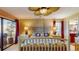 Bedroom with ceiling fan, bedside tables, and sliding glass doors to a balcony overlooking a green space at 7867 Sailboat Key S Blvd # 101, South Pasadena, FL 33707