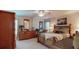 Bedroom with wooden furniture, including dresser and bed, featuring a tropical-themed decor and bright windows at 7867 Sailboat Key S Blvd # 101, South Pasadena, FL 33707