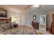 Bedroom with a comfortable bed, chest of drawers, and a view of the ensuite bathroom at 7867 Sailboat Key S Blvd # 101, South Pasadena, FL 33707