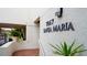 Close up of building sign '7867 Santa Maria' with tropical foliage and architectural details at 7867 Sailboat Key S Blvd # 101, South Pasadena, FL 33707