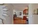 Hallway view leading to dining area and kitchen, featuring wood floors and neutral walls at 7867 Sailboat Key S Blvd # 101, South Pasadena, FL 33707