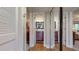 Hallway leading to bedrooms and bathrooms with mirrored closet doors and wood-style flooring at 7867 Sailboat Key S Blvd # 101, South Pasadena, FL 33707