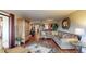 Comfortable living room with a brown L-shaped couch, wood floors, and sliding glass doors to a balcony at 7867 Sailboat Key S Blvd # 101, South Pasadena, FL 33707