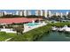 Community pool area with lounge chairs, surrounded by lush landscaping and waterfront views at 7867 Sailboat Key S Blvd # 101, South Pasadena, FL 33707
