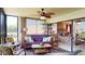 Inviting sunroom with a futon and views of the lake, complemented by palm-themed decor at 7867 Sailboat Key S Blvd # 101, South Pasadena, FL 33707