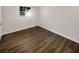 Empty bedroom features hardwood floors, fresh paint, and a bright window at 8065 70Th N St, Pinellas Park, FL 33781