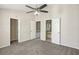 This bedroom features a neutral paint, gray carpet and three access doors at 8101 Interbay Blvd # A, Tampa, FL 33616