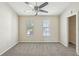 Bright bedroom features two windows with blinds, neutral walls and gray carpet at 8101 Interbay Blvd # A, Tampa, FL 33616