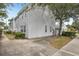Gray two-story condo with a parking area and manicured shrubs at 8101 Interbay Blvd # A, Tampa, FL 33616