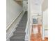 Interior view of the hallway with stairs, light walls, tiled flooring, and a glimpse of the living space beyond at 8101 Interbay Blvd # A, Tampa, FL 33616