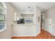 Bright kitchen featuring white cabinets, black appliances, and a convenient breakfast bar at 8101 Interbay Blvd # A, Tampa, FL 33616
