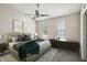 Bedroom featuring a large bed, two windows, a ceiling fan, and contemporary décor at 8101 Interbay Blvd # A, Tampa, FL 33616